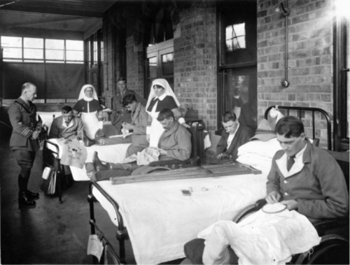 Returned servicemen doing embroidery in their hospital beds 